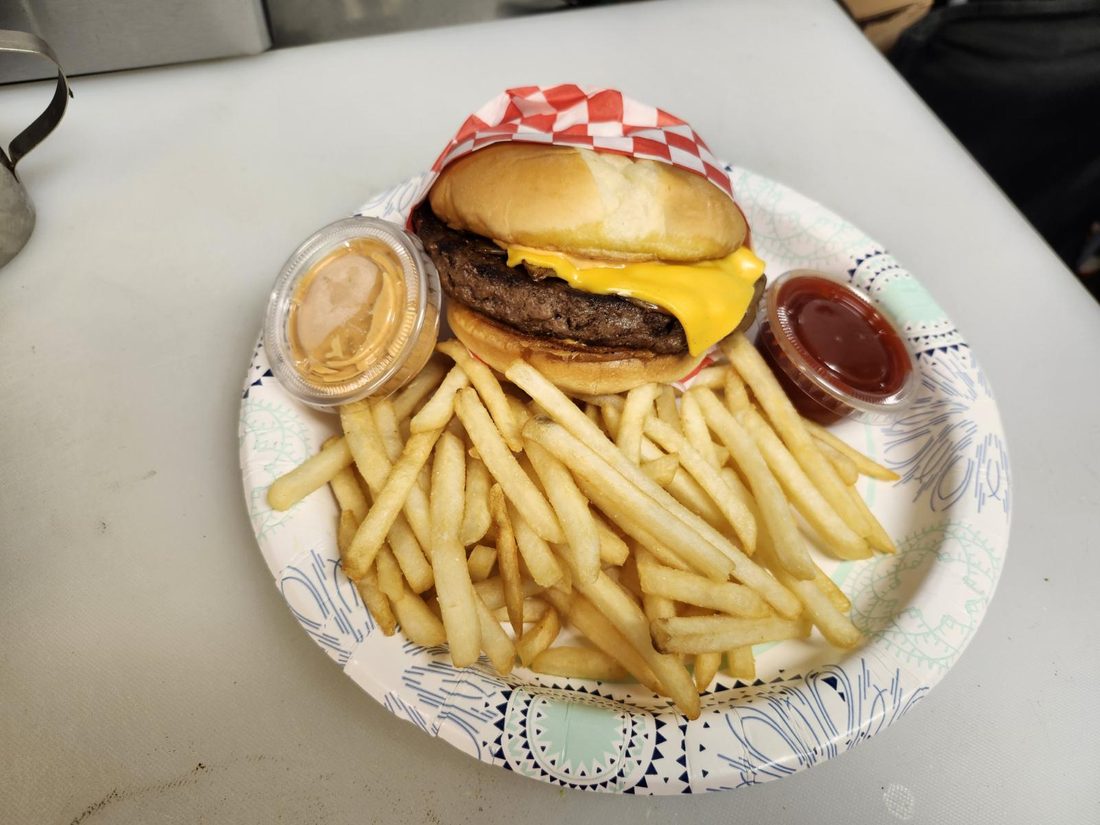 Cheeseburger served with fries.