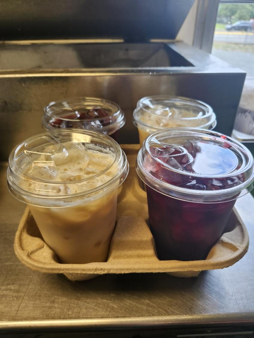 Iced horchata and hibiscus drinks on a tray.