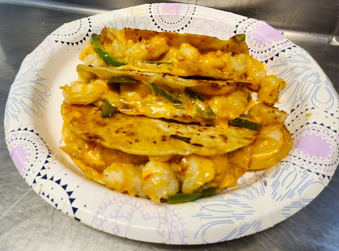 Three shrimp quesadillas on a plate.